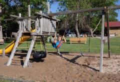 Kid swinging on a playset