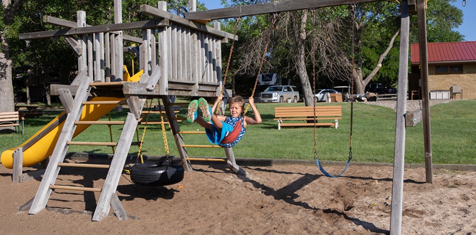 Kid swinging on a playset