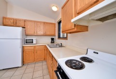 Kitchen with fridge, microwave, sink, coffee maker, and oven