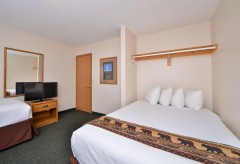 Queen bed with a single bed and tv