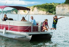 Kids jumping off a pontoon into the water